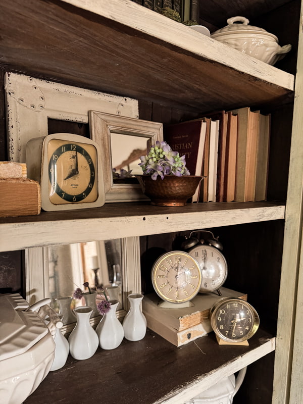 shelf styling with old clocks grouped in uneven numbers for visual appeal.  