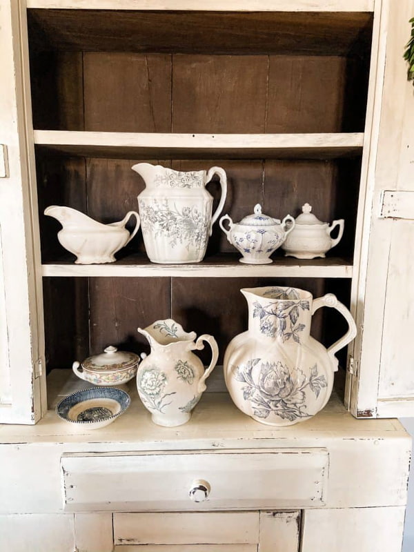 Blue and white transferware collection on antique cupboard.  
