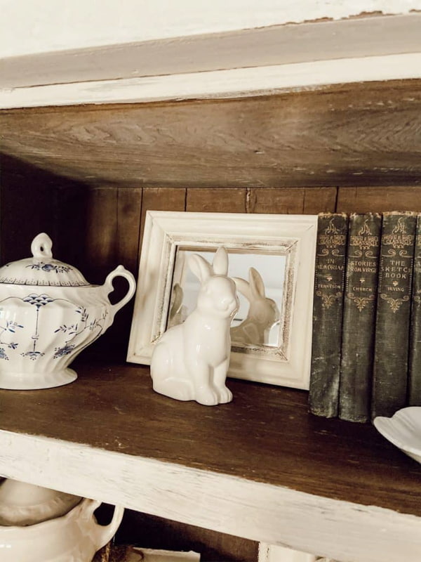 Vintage Books and seasonal decor for decorations on shelves in antique cabinets.  