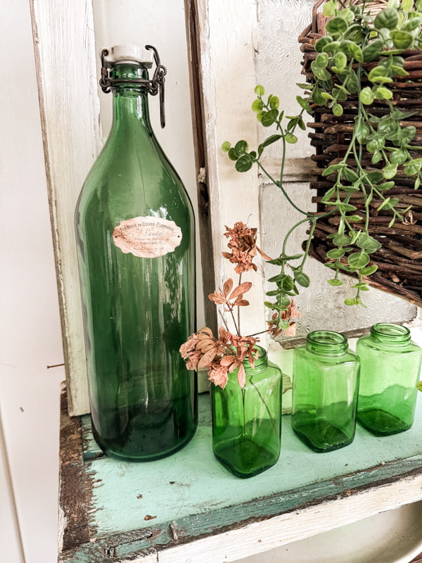 Vintage green bottles with faux antique labels for fall decorating.  