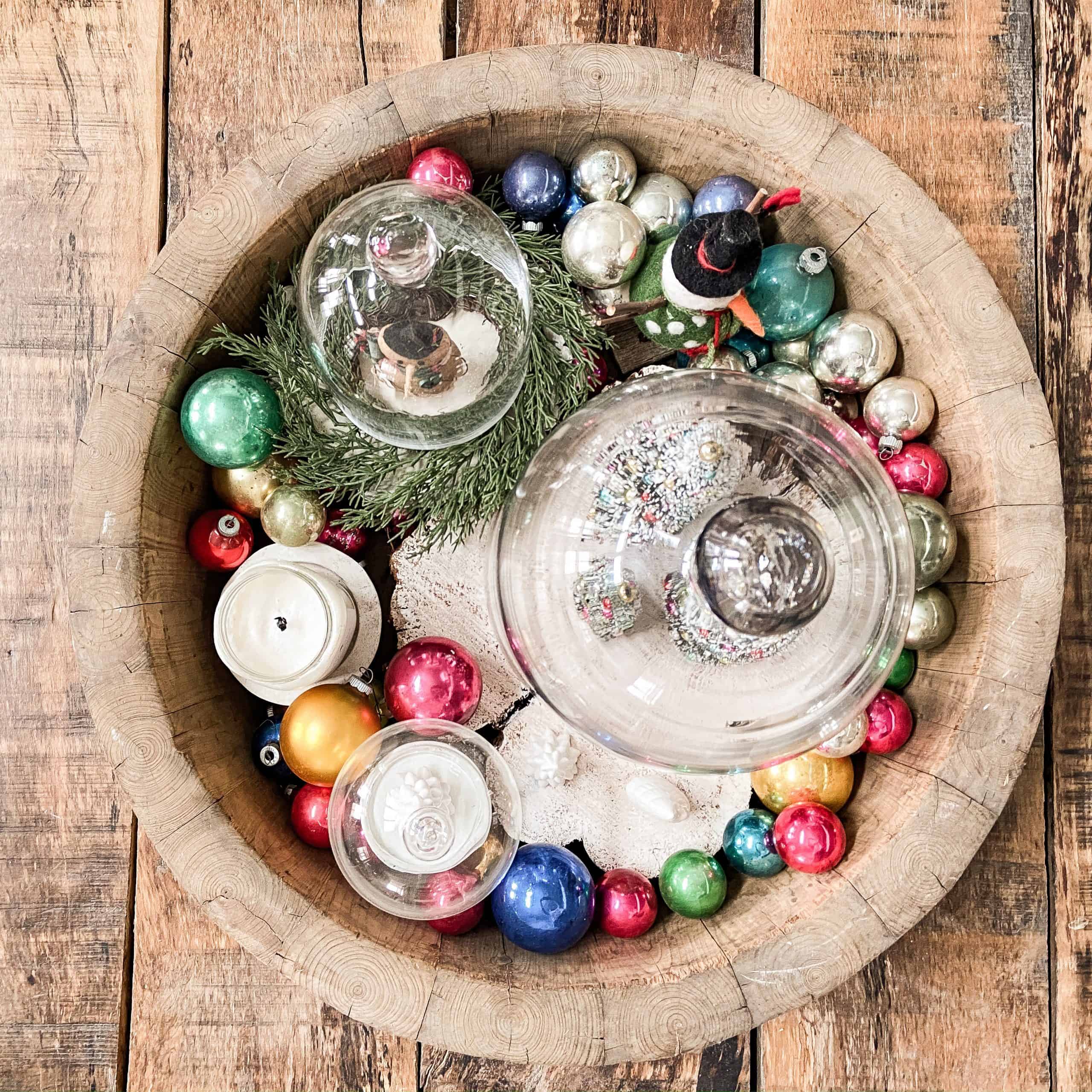 Vintage shiny brite ornaments in wooden bowl with glass cloches.  