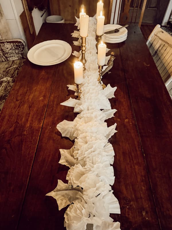 DIY floral garland made from coffee filters. coffee filter garland on dining table.