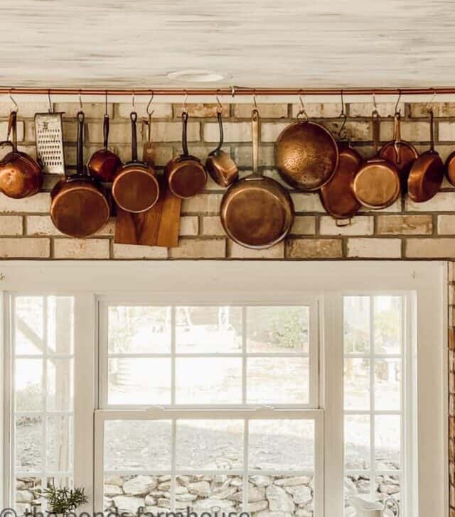 cropped-Close-up-DIY-Copper-Pot-Hanging-Rack-copper-pots-on-brick-wall-in-kitchen.jpg