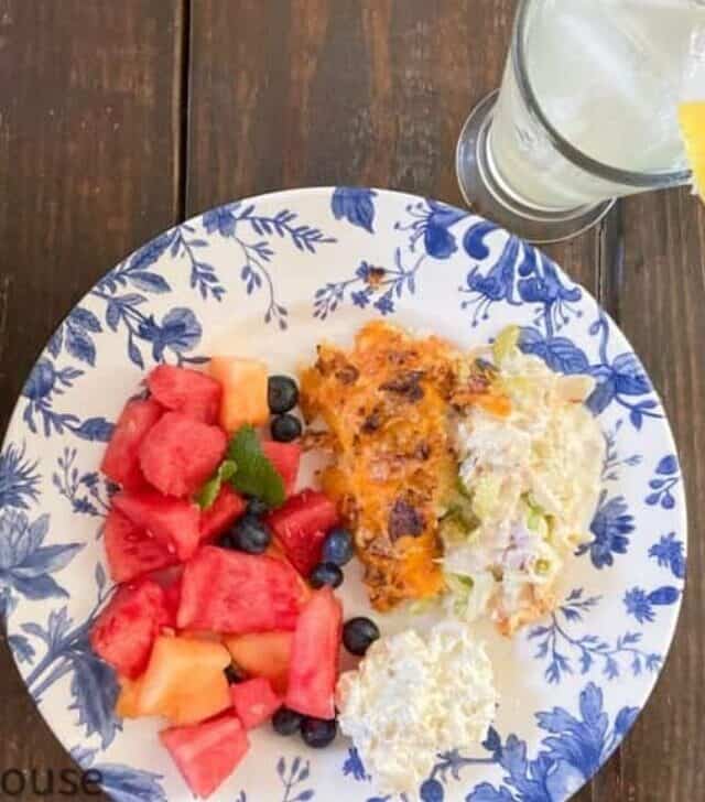 cropped-Hot-Chicken-Salad-with-Fruit-Salad-on-Blue-White-Plate-with-Lemonade.jpg