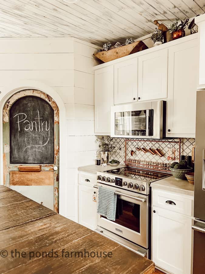 https://www.thepondsfarmhouse.com/wp-content/uploads/2023/06/Pantry-Door-with-Stove-and-over-head-cabinets.jpg