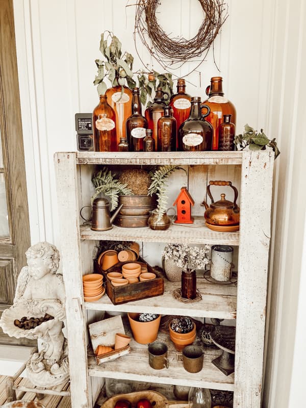 https://www.thepondsfarmhouse.com/wp-content/uploads/2023/08/Amber-Bottles-Vintage-Amber-Bottles-on-porch-cabinet.jpg