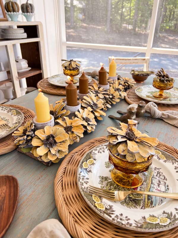 Sunflower Craft Ideas using pinecones to make a centerpiece with candles and reclaimed wood.