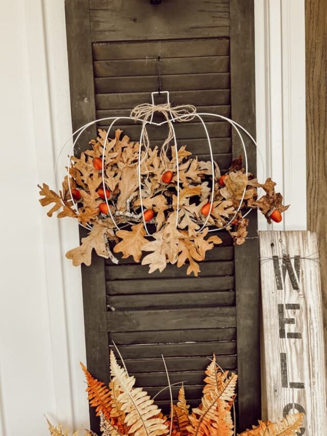 DIY Dollar Tree Pumpkin fall decoration hanging on shutter of farmhouse.