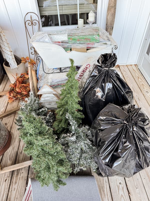 Christmas containers stacked on front porch