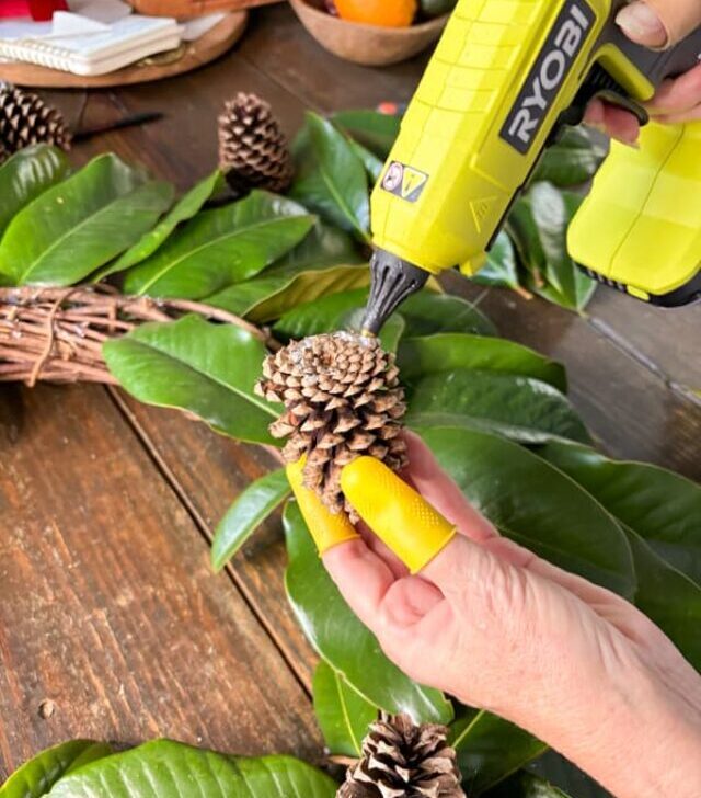 cropped-hot-glue-to-pinecone-for-Antler-Christmas-Wreath.jpg