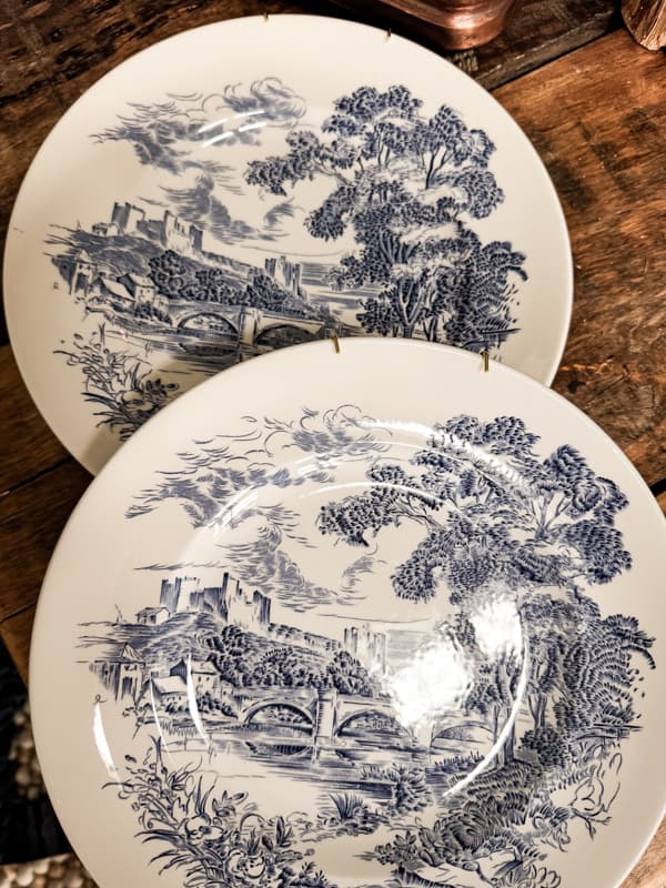 Decorating plates on wall with vintage thrift store dishes and antique finds.  Blue and White plates to create unique plate wall display 