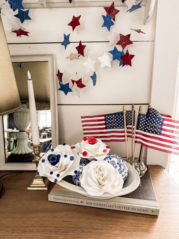 white paper roses with vintage red, white, and blue buttons for patriotic decorations. 