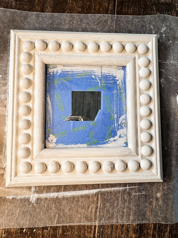 Painted beaded mirror frame with old white chalk paint.  
