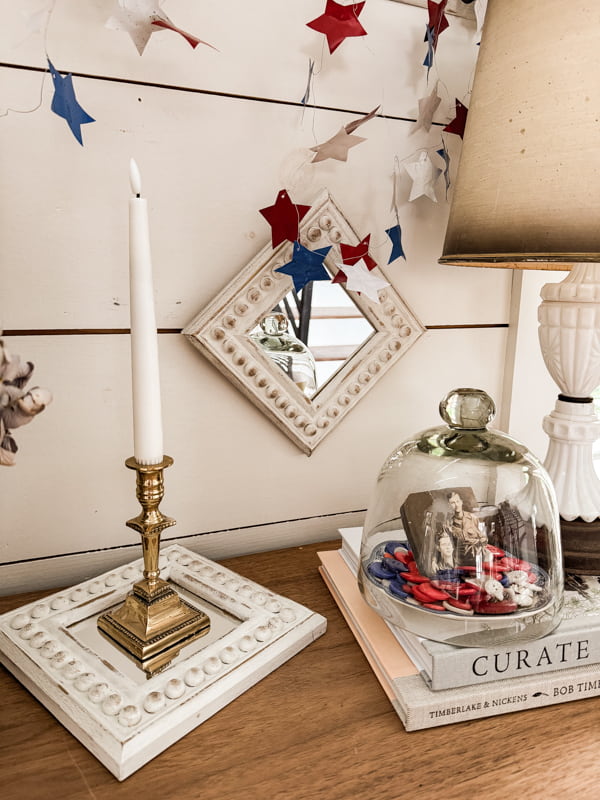 Bead wood frame mirrors with patriotic touches on entry table.  