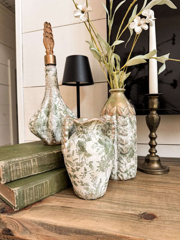 Magnolia Vase knock-off vignette on mantel with vintage candlestick and old green books