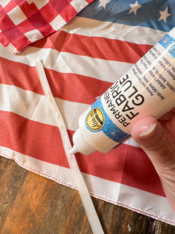 Add fabric glue to velcro to create a patriotic pillow cover.  