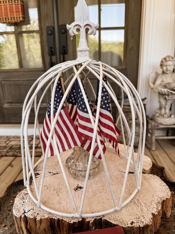 Metal Garden Cloche with vintage glass flower frog and american flags.