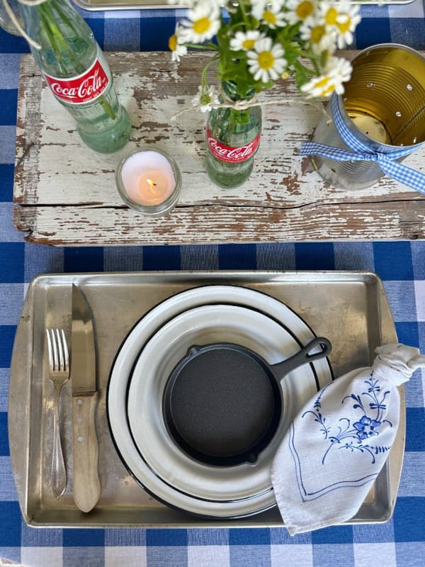 Rustic outdoor table with vintage inspired decor and rustic table setting.
