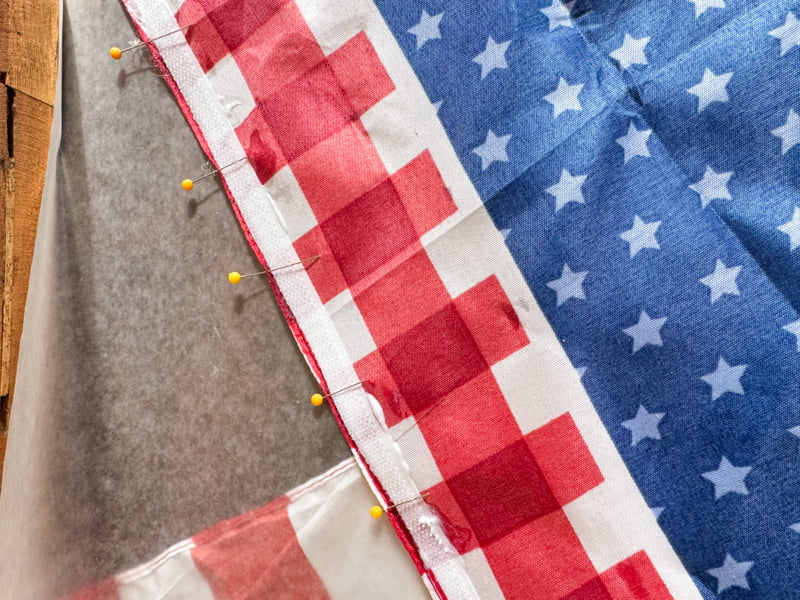 Add pins to hold velcro in place on the no-sew Dollar Tree Pillow Cover.