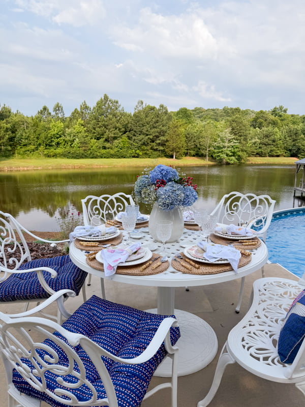 Poolside Dining Table filled with thrift store tableware and DIY projects.  