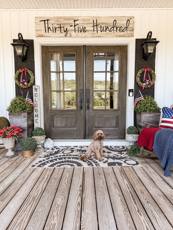 Rudy at front doors with patriotic red, white and blue decorations for the 4th of July