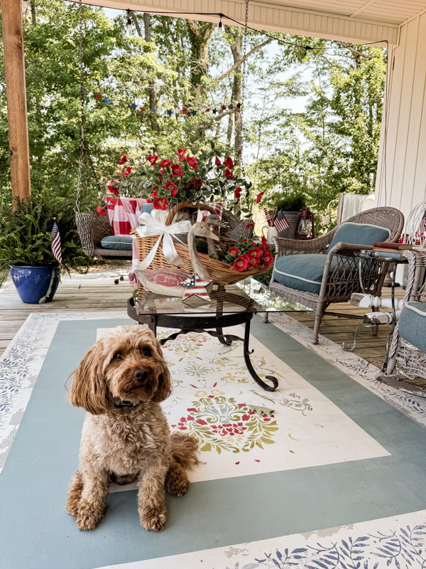 Front porch seating area with rustic red, white and blue decorations .