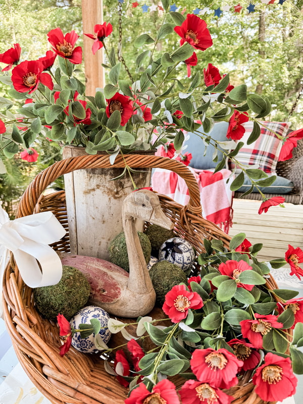 Scoop basket with rustic decor on coffee table for summer porch decorations.