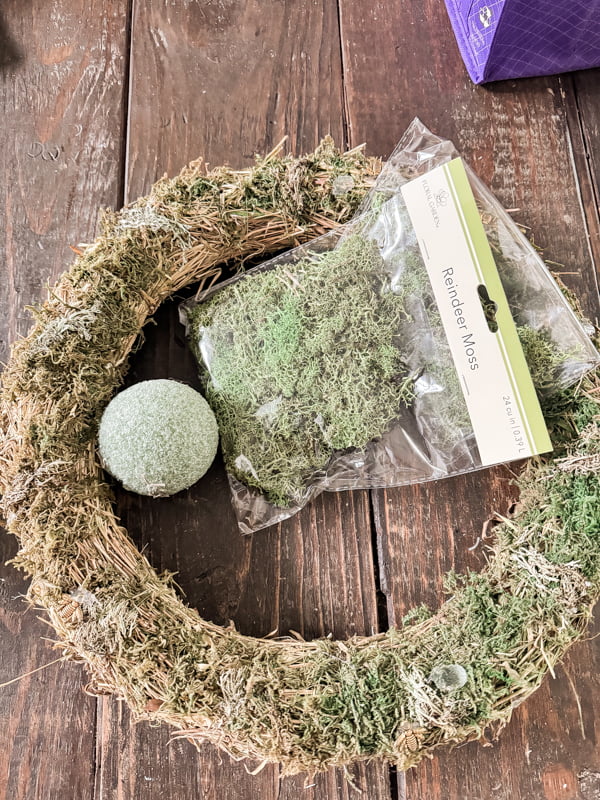add styrofoam ball to moss wreath frame and refresh with reindeer moss for a recycled wreath.  