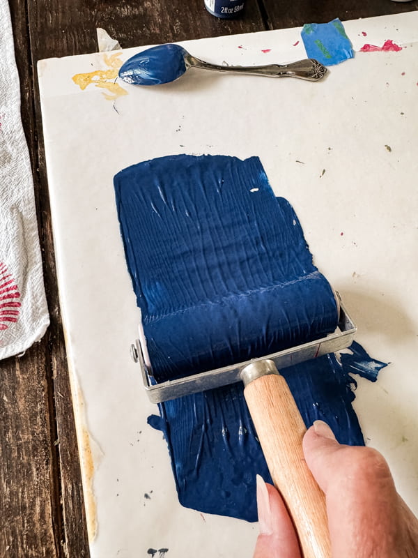 Roll paint to flatten with brayer roller