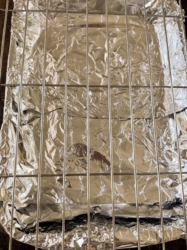 Drip pan covered in aluminum foil.  