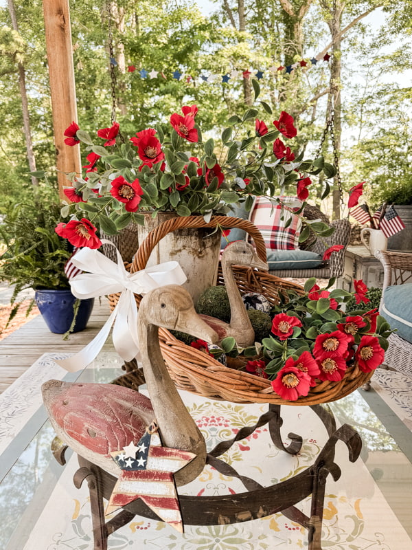 Scoop basket with rustic decor on coffee table for summer porch decorations.