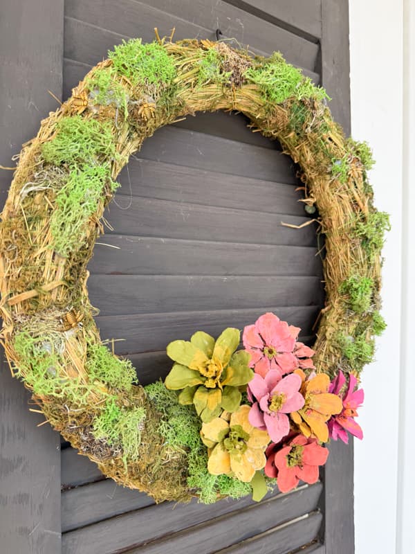 Summertime Wreath Ideas with pinecones that look like zinnias on a moss wreath.