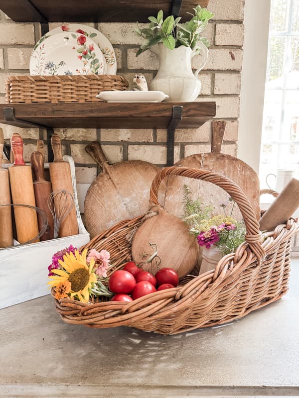 Scoop basket with breadboards and flowers and tomatoes