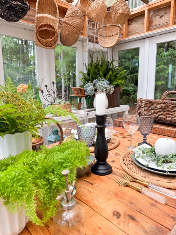 thrifted wooden candlestick holder and milk glass vases on summer tablescape.  