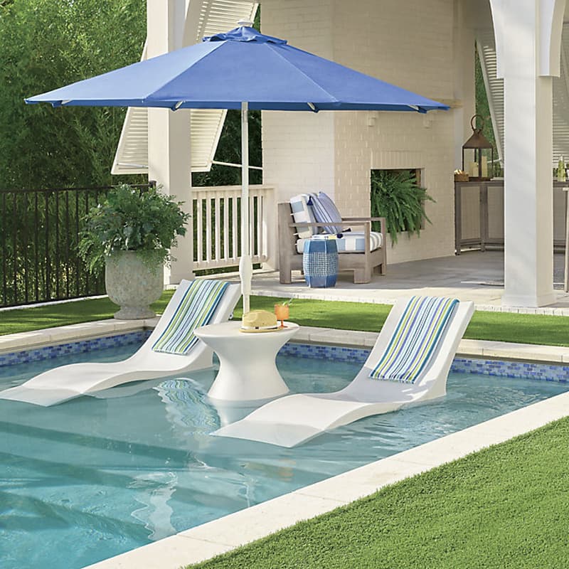 Pool floats with side table for umbrella stand from Frontgate with blue and green stripped towels