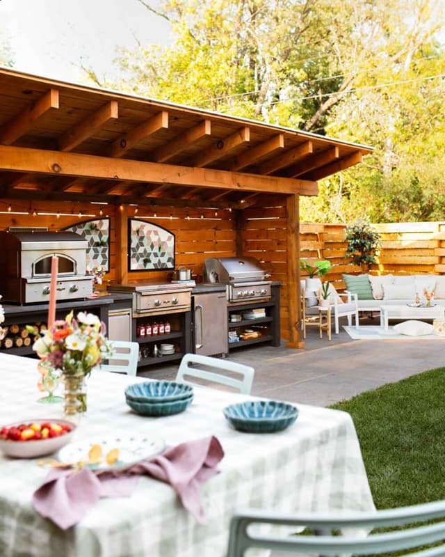 Outdoor Kitchen with seating area and table with checked table cloth.  