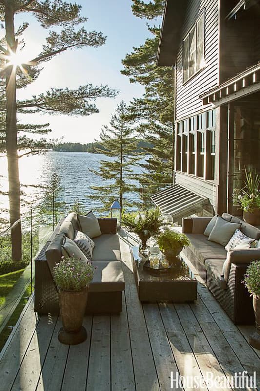 Outdoor living space with rustic deck overlooking water 