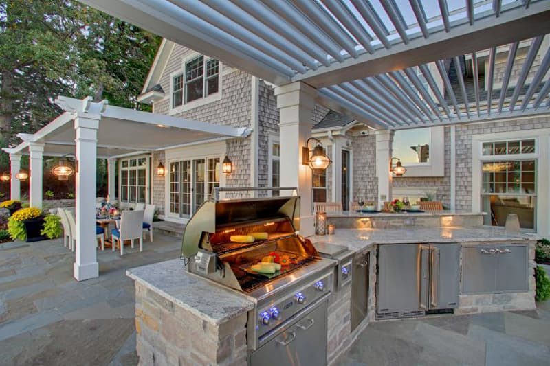 Outdoor grill in outdoor living space in backyard kitchen.