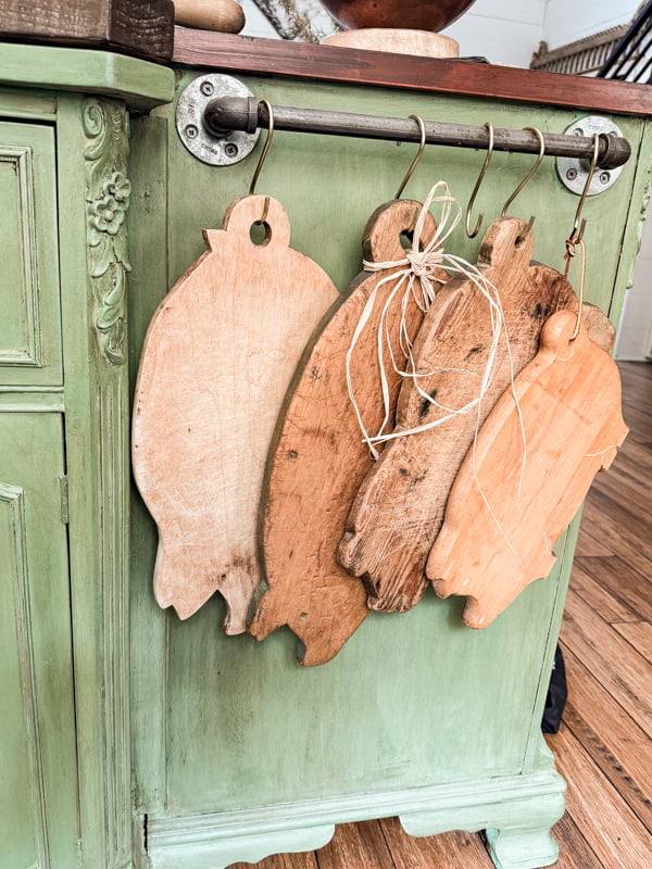 Decorating with Breadboards and Cutting Boards. Pig breadboards hanging on farmhouse kitchen island. 