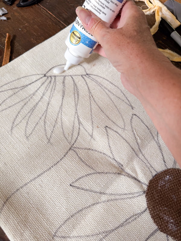 Add glue to the center of the flowers and apply brown burlap fabric.