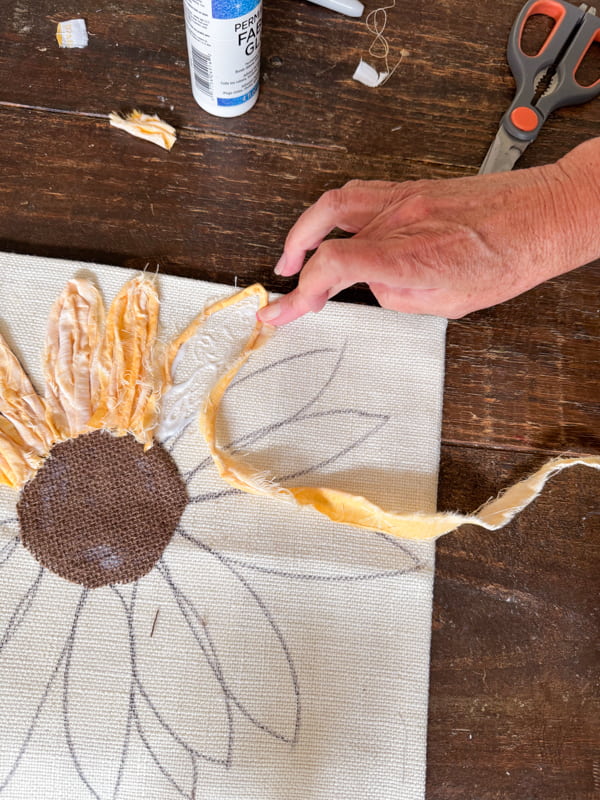 twist the yellow scrap fabric and press into the glue to form the sunflower petals.  