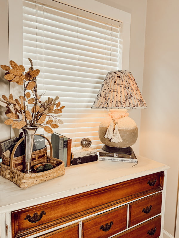 Pleated Fabric lampshade on a Repurposed thrift store lamp on bedroom chest with fall leaves.  