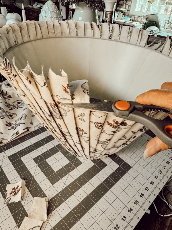 Cut ends of the pleated fabric lampshade from the bottom. 