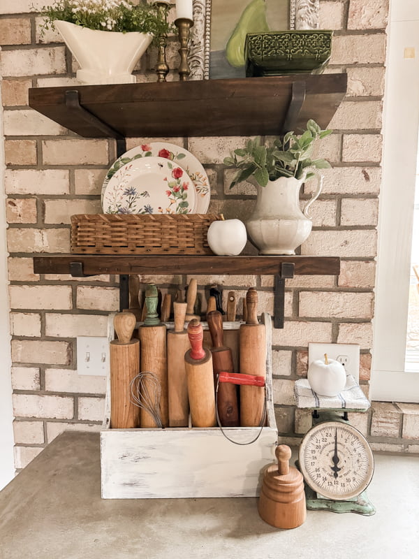 Upcycled Plastic Apples into elegant White and Gold Apple Decorations on rustic open kitchen shelves with vintage rolling pins.