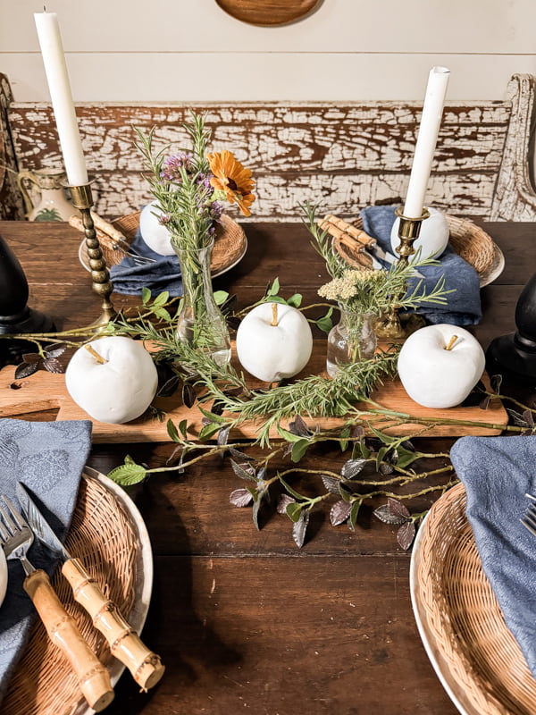 Bread board with apple centerpiece and greenery.  