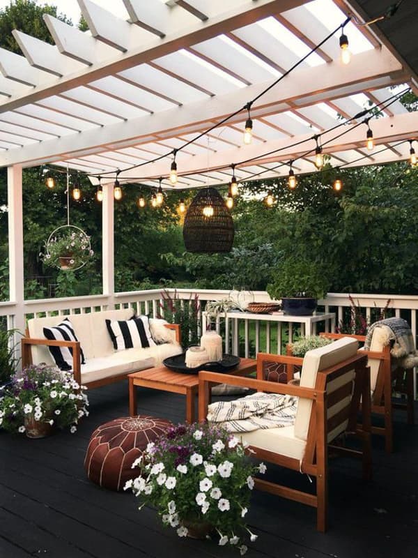 Cozy deck with pergola and string lights overhead.  Budget outdoor living space ideas.