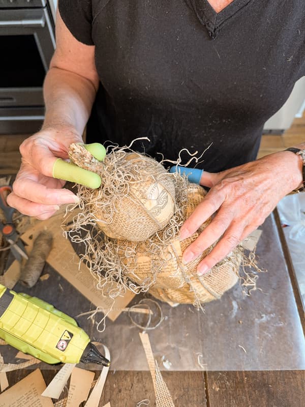 Add spanish moss and stick to the top of the DIY Pumpkin Topiaries for a primitive fall craft.