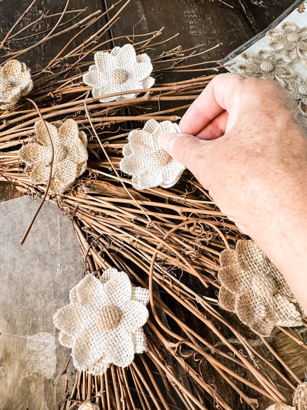 Add burlap flower stickers randomly  with hot glue.  