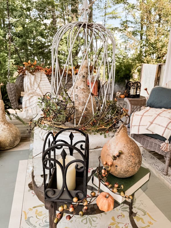 Coffee Table centerpiece with architectural column base and metal cloche over a dried gourd.  