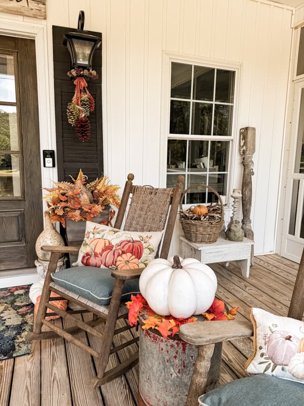 Front Porch Decorating ideas for fall with rocking chairs and cozy pllows.  Pumpkins and gourds.  